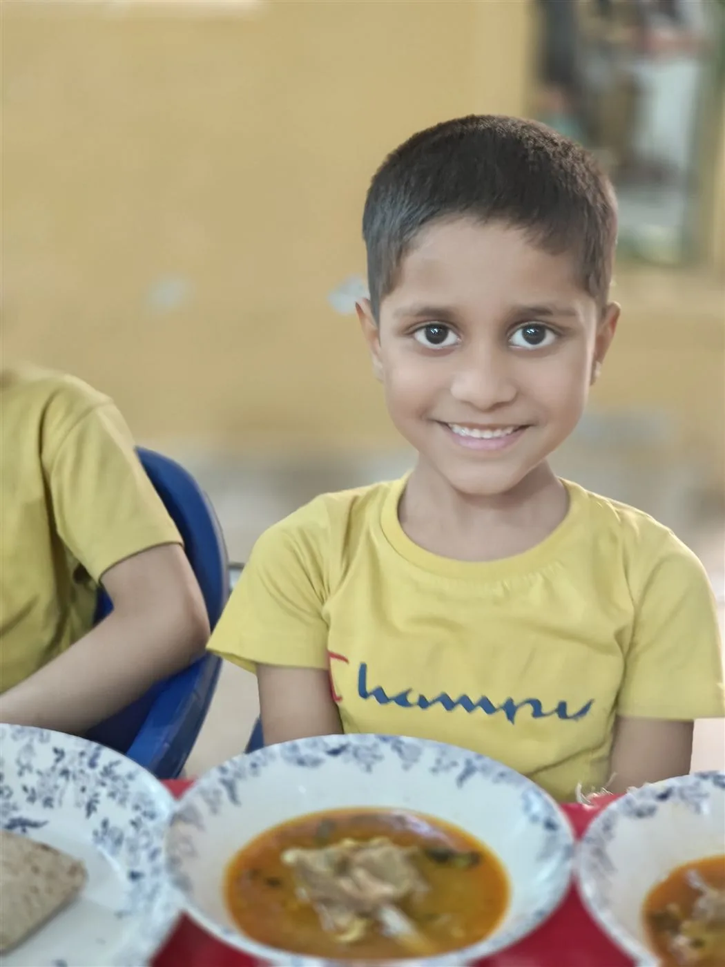 A child at mealtime at the Aasra Children's Home